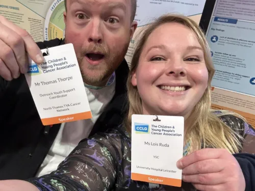 Lois and Tom holding their attendee badges from the CCLG Annual Conference.