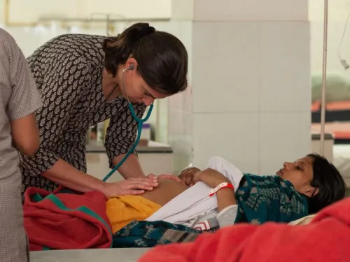 A doctor examining a young girl in a hospital bed